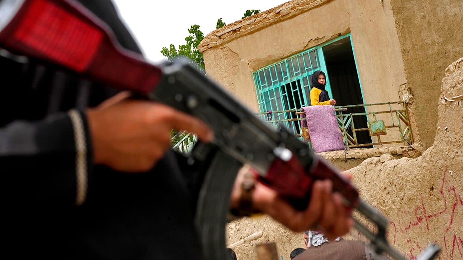 A Taliban fighter stands guard at the site of an explosion in front of a school in Kabul, Afghanistan, on April 19, 2022.