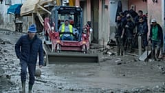 Workers clear mud and debris from a street in Casamicciola.