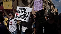 Protesters carry placards and walk through Valletta's streets during an abortion rights rally on September 25, 2022 in Valletta, Malta. 