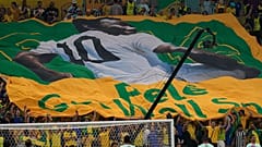 Football fans hold a giant Brazilian flag with a picture of Brazilian football legend Pele with a message "Pele, Get well soon" in Qatar, 2 December 2022