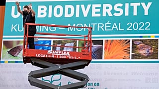 Workers set up the Montreal Convention Centre in preparation for the COP15 UN conference on biodiversity in Montreal.