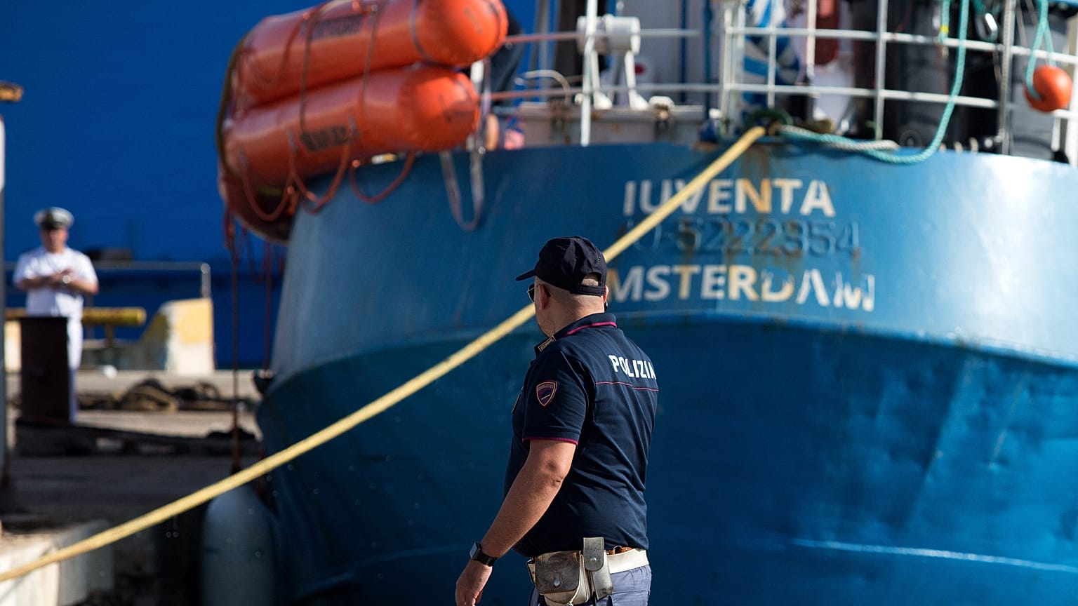 An Italian police officer stands by the Iuventa rescue ship run by German NGO Jugend Rettet (Youth Saves) arrives at the harbour of Trapani on August 4, 2017.