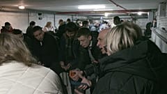 Ukrainians and UN officials in a bunker during an air raid in Kyiv