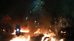 Flaming rubbish bins outside the Ippokrateio General Hospital, in Greece's second largest city of Thessaloniki, on Monday, Dec 5, 2022.