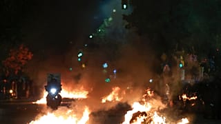 Flaming rubbish bins outside the Ippokrateio General Hospital, in Greece's second largest city of Thessaloniki, on Monday, Dec 5, 2022.