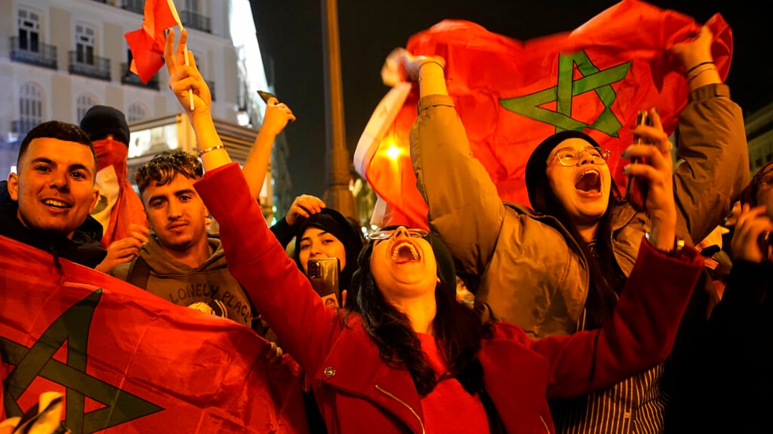 Morocco's supporters celebrate after their team won the Qatar 2022 World Cup round 16 football match between Morocco and Spain, at the FIFA fan zone in Doha, 6/12/2022.