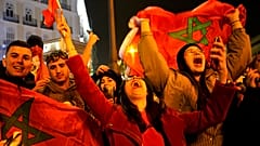 Morocco's supporters celebrate after their team won the Qatar 2022 World Cup round 16 football match between Morocco and Spain, at the FIFA fan zone in Doha, 6/12/2022.