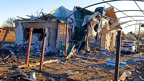 A damaged building and car are seen after a Russian strike in the village of Novosofiivka, in the Zaporizhzhia region, Ukraine, Monday, 5 December 2022.