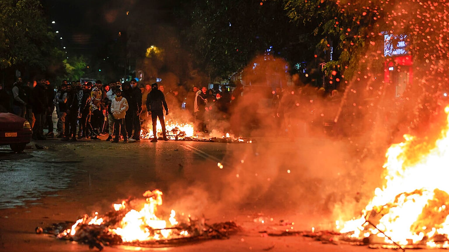 People blocking a main road set fire to rubbish bins outside the Ippokrateio General Hospital, in Greece's second largest city of Thessaloniki, on Monday, Dec 5, 2022. 