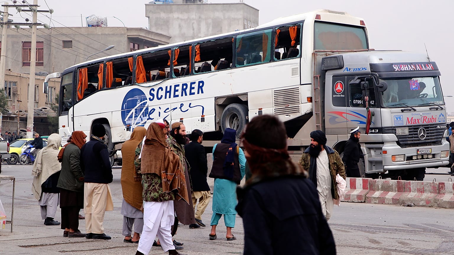 Taliban security personnel carry a damaged bus after a roadside bomb blast in Mazar-e Sharif, the capital city of Balkh province, in northern Afghanistan. Tuesday, 6 Dec. 2022