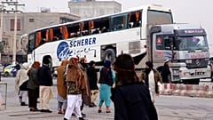 Taliban security personnel carry a damaged bus after a roadside bomb blast in Mazar-e Sharif, the capital city of Balkh province, in northern Afghanistan. Tuesday, 6 Dec. 2022