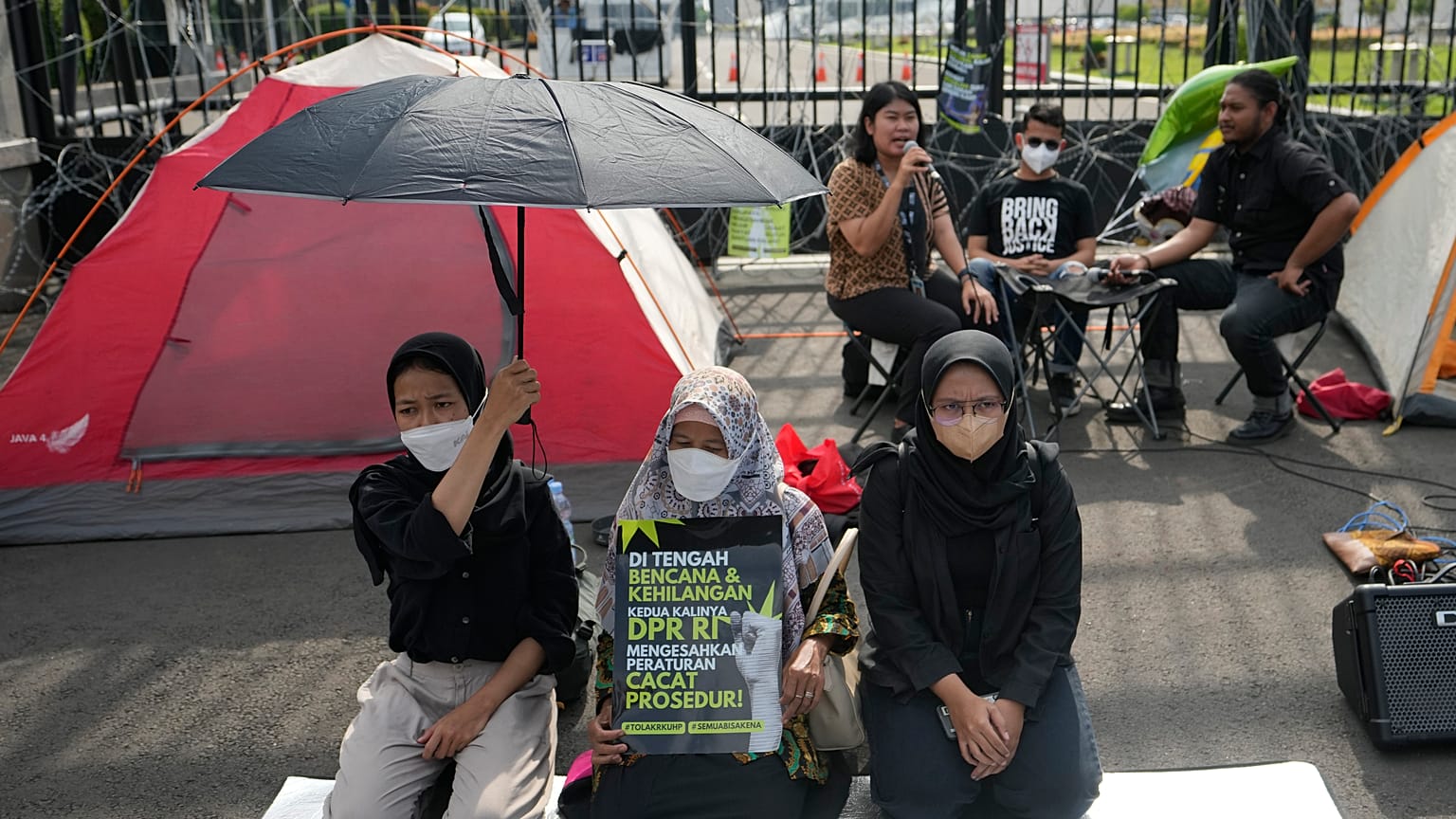 Activists protest in front of the parliament building in Jakarta, Indonesia, Tuesday 6 Dec 2022