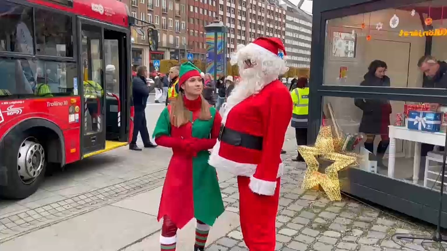 Santa and his helper stand outside the trolley bus in Budapest, Hungary.