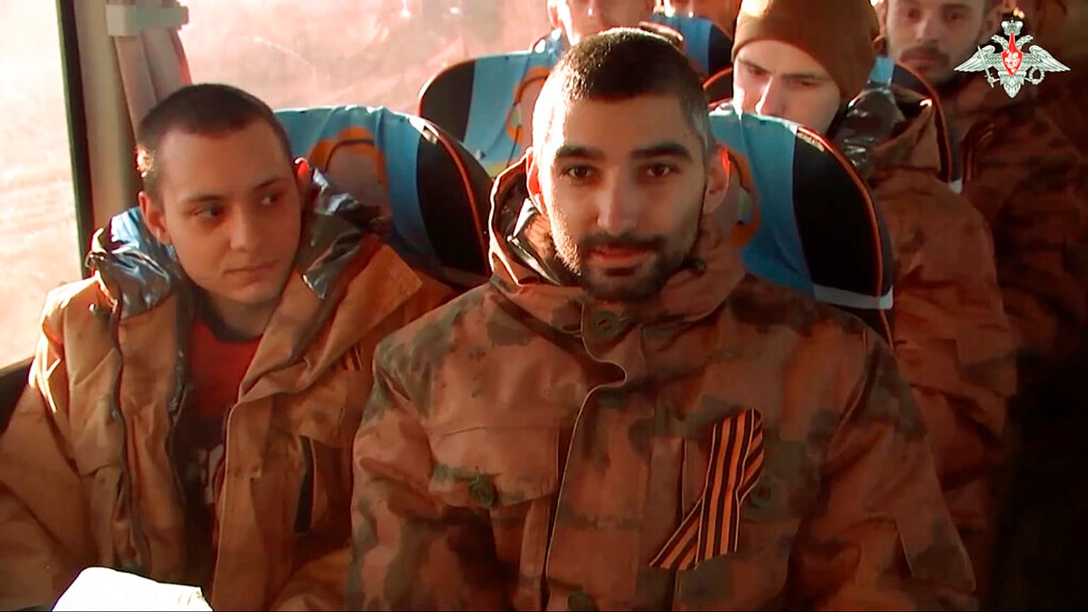 A group of Russian soldiers sit in a bus after being released in bilateral prisoner swap
