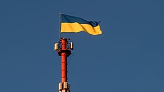 The Ukrainian flag flutters on top of the Daugavpils TV and Radio tower in Daugavpils, a southeastern Latvian city.