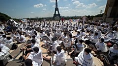 FILE: Demonstrators dressed as mime artists hold placards which read "no to the euthanasia of elderly people, solidarity is urgent", in Paris, June 2014