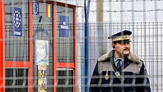  Romanian border police officer stands guard at the railway border crossing point between Romania and Moldova in Ungheni, Romania, on Jan. 18, 2011. 