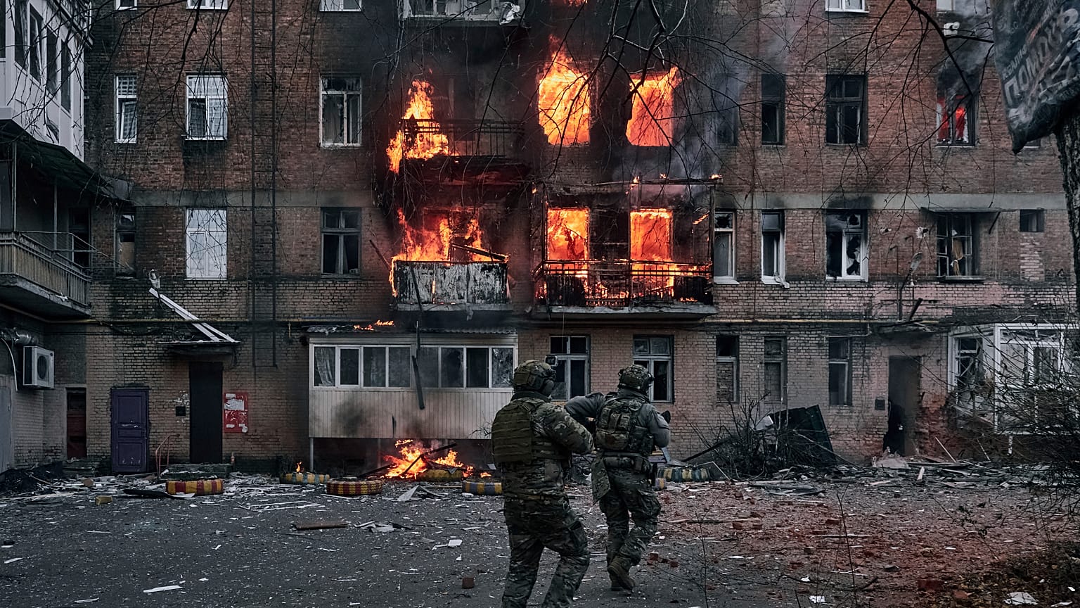 Ukrainian soldiers rush to an apartment fire after the Russian shelling in Bakhmut, Donetsk region.