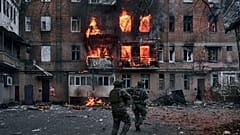 Ukrainian soldiers rush to an apartment fire after the Russian shelling in Bakhmut, Donetsk region.