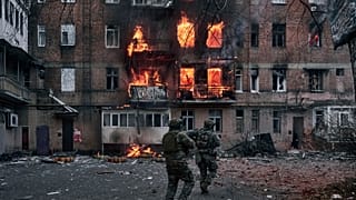 Ukrainian soldiers rush to an apartment fire after the Russian shelling in Bakhmut, Donetsk region.