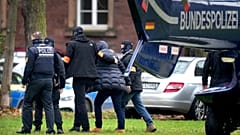 d right, is escorted from a police helicopter by police officers after the arrival in Karlsruhe, Germany, Wednesday, Dec. 7, 2022. 