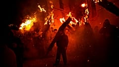 Villagers hold burning brooms during 'Los Escobazos' Festival in Jarandilla de la Vera, Spain