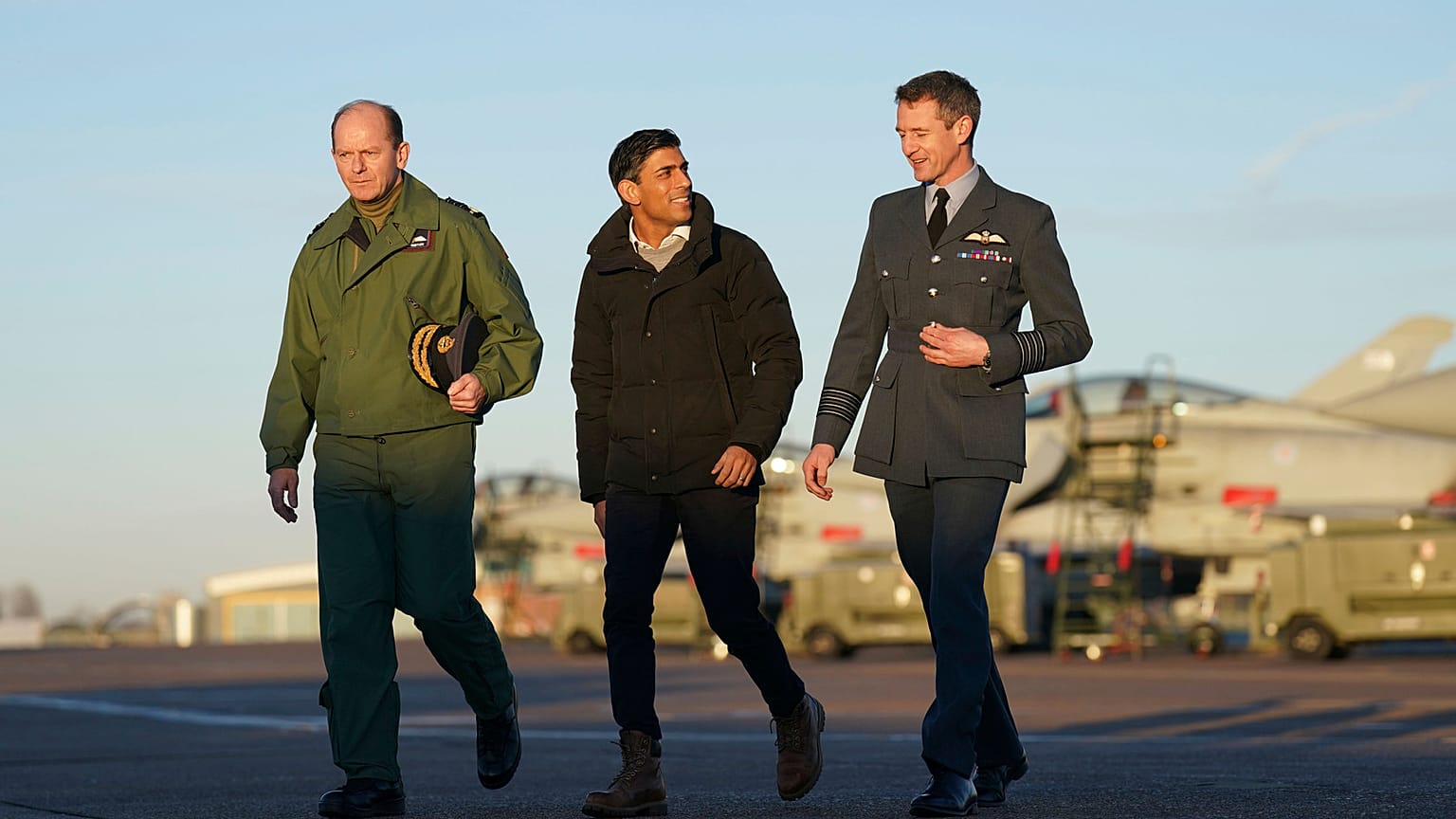 Air Chief Marshal Mike Wigston, left and Station Commander for RAF Coningsby Billy Cooper walk with UK PM Rishi Sunak during his visit to RAF Coningsby. Friday, 9 Dec. 2022.