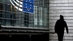 A man walks near the entrance of the European Parliament in Brussels on December 9, 2022.