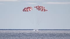The Orion capsule is seen Sunday, December 11, 2022, parachuting into the Pacific off Mexico to conclude a dramatic 25-day test flight.