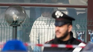 Bűnügyi helyszínelők végzik a dolgukat a római bárban, ahol a lövöldözés történ - a helyszínt rendőri felügyelet alatt tartják