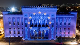 The European Union flag is projected on the National Library building in Sarajevo, Bosnia, Oct. 12, 2022. 
