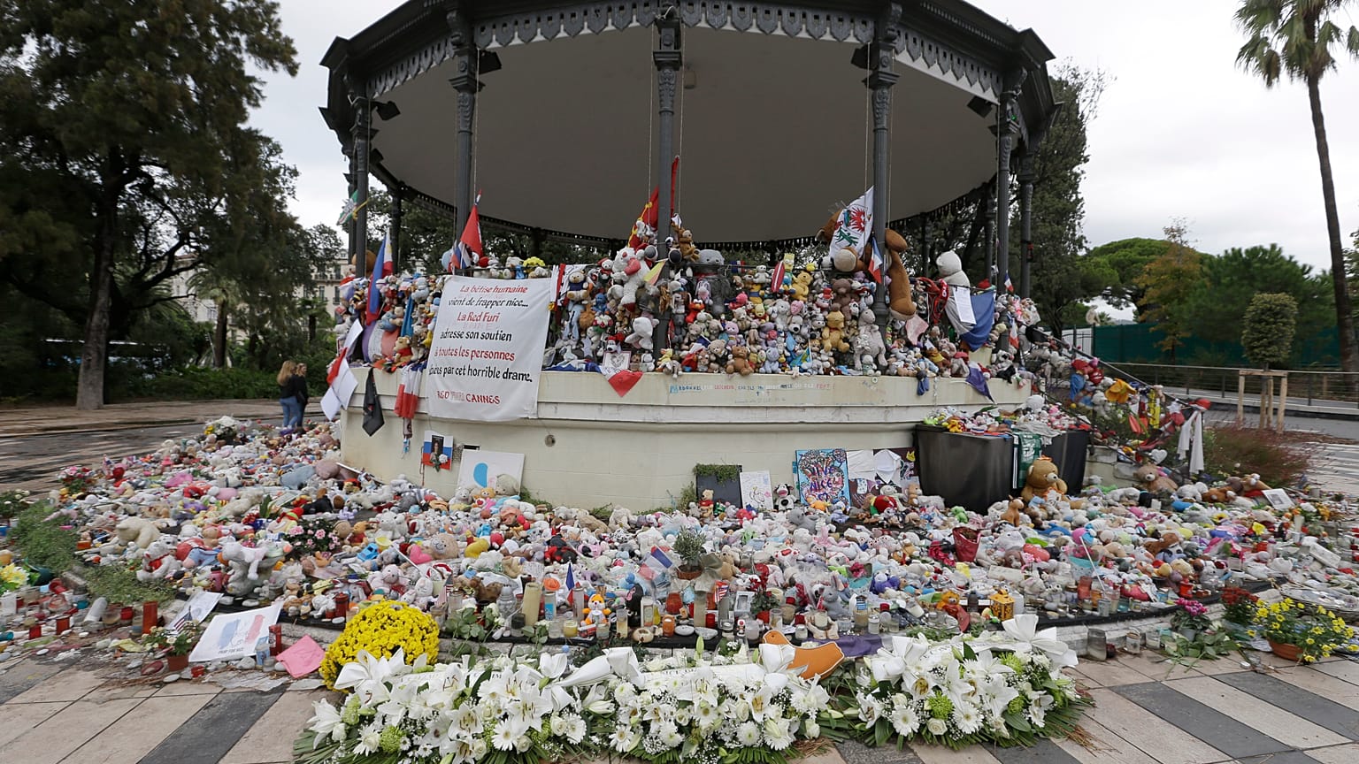 Flowers pile up at a makeshift memorial in a park on the Nice's famed Promenade des Anglais.