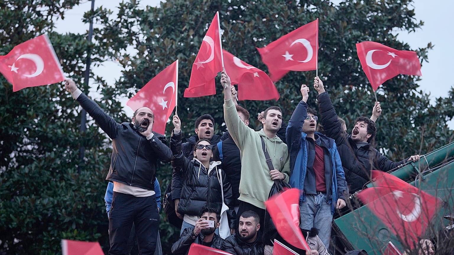 Supporters of Istanbul Mayor Ekrem Imamoglu chant slogans as they gather in front of the municipal building in Istanbul, Wednesday, Dec. 14, 2022. 