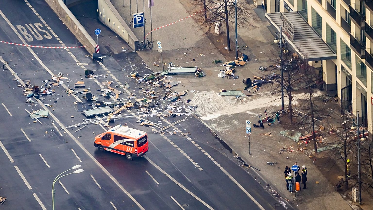 Debris is scattered on the street outside the building where the aquarium burst.