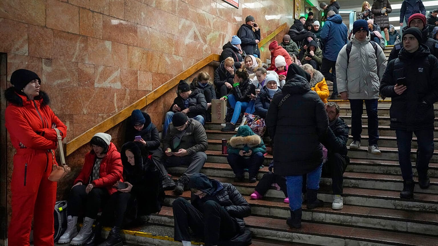People rest in the subway station, being used as a bomb shelter during a rocket attack in Kyiv, Ukraine, Friday, Dec. 16, 2022. 