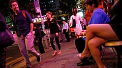 Nyugati turista figyel egy prostituáltat Hongkong vigalmi negyedében