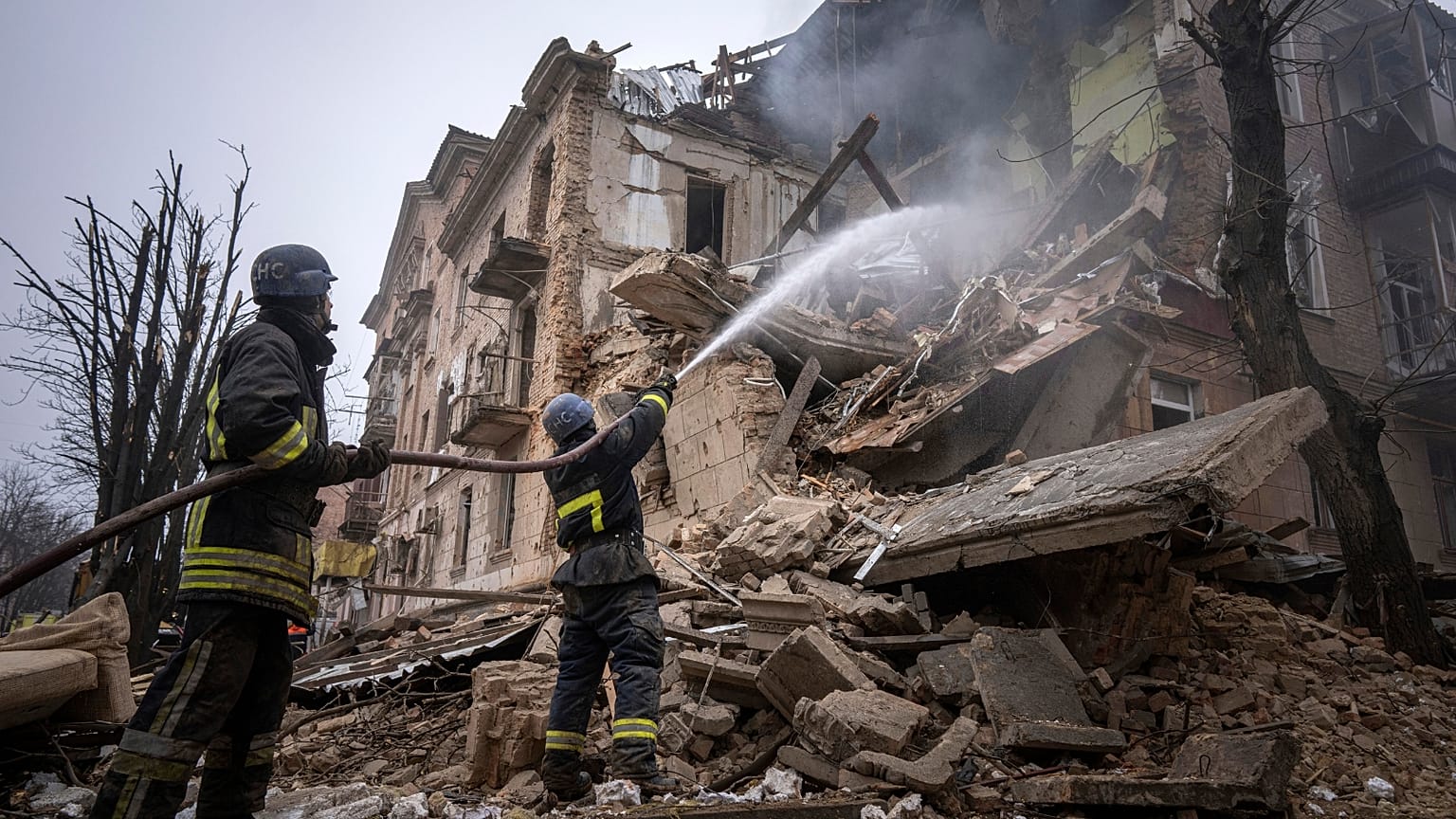 Ukrainian State Emergency Service firefighters work to extinguish a fire at the building which was destroyed by a Russian attack in Kryvyi Rih, Ukraine, Friday, Dec. 16, 2022.