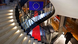 FILE - A man walks down stairs during a special session on lobbying at the European Parliament in Strasbourg, eastern France, Dec. 12, 2022.