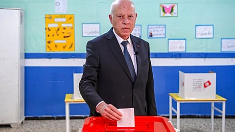 Tunisia's President Kais Saied casts his ballot as he participates in the legislative elections in Tunis, Saturday, Dec. 17, 2022. 