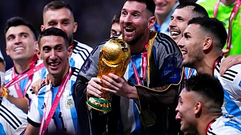 Argentina's bisht wearing captain Lionel Messi holds up the World Cup  