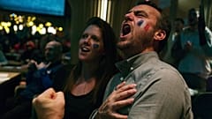 Fans sing "La Marsellaise," the French national anthem, in Paris as their team scores a third goal. 