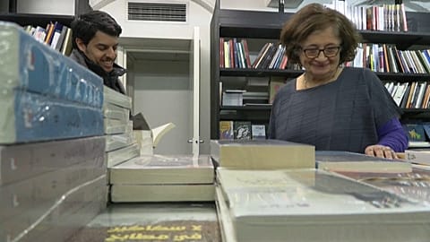 Al Saqi bookshop co-founder Salwa Gaspard speaking to a customer. 