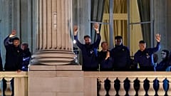France supporters applaud French players at the balcony of the Hotel Crillon, Monday, Dec. 19, 2022 in Paris. 