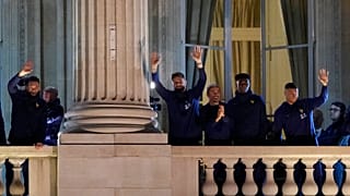 France supporters applaud French players at the balcony of the Hotel Crillon, Monday, Dec. 19, 2022 in Paris.