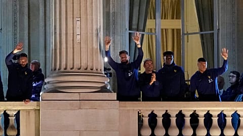 France supporters applaud French players at the balcony of the Hotel Crillon, Monday, Dec. 19, 2022 in Paris. 