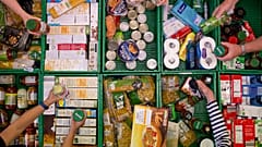 Overhead shot of crates and volunteers holding items