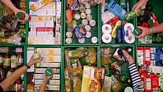Overhead shot of crates and volunteers holding items