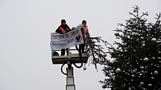 Ativistas do grupo "Última Geração", após cortarem a Árvore de Natal da Porta de Brandeburgo, em Berlim