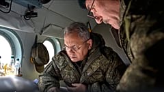Russian Defence Minister Sergei Shoigu looks at documents aboard a military helicopter at an undisclosed location in Ukraine, 18 December 2022