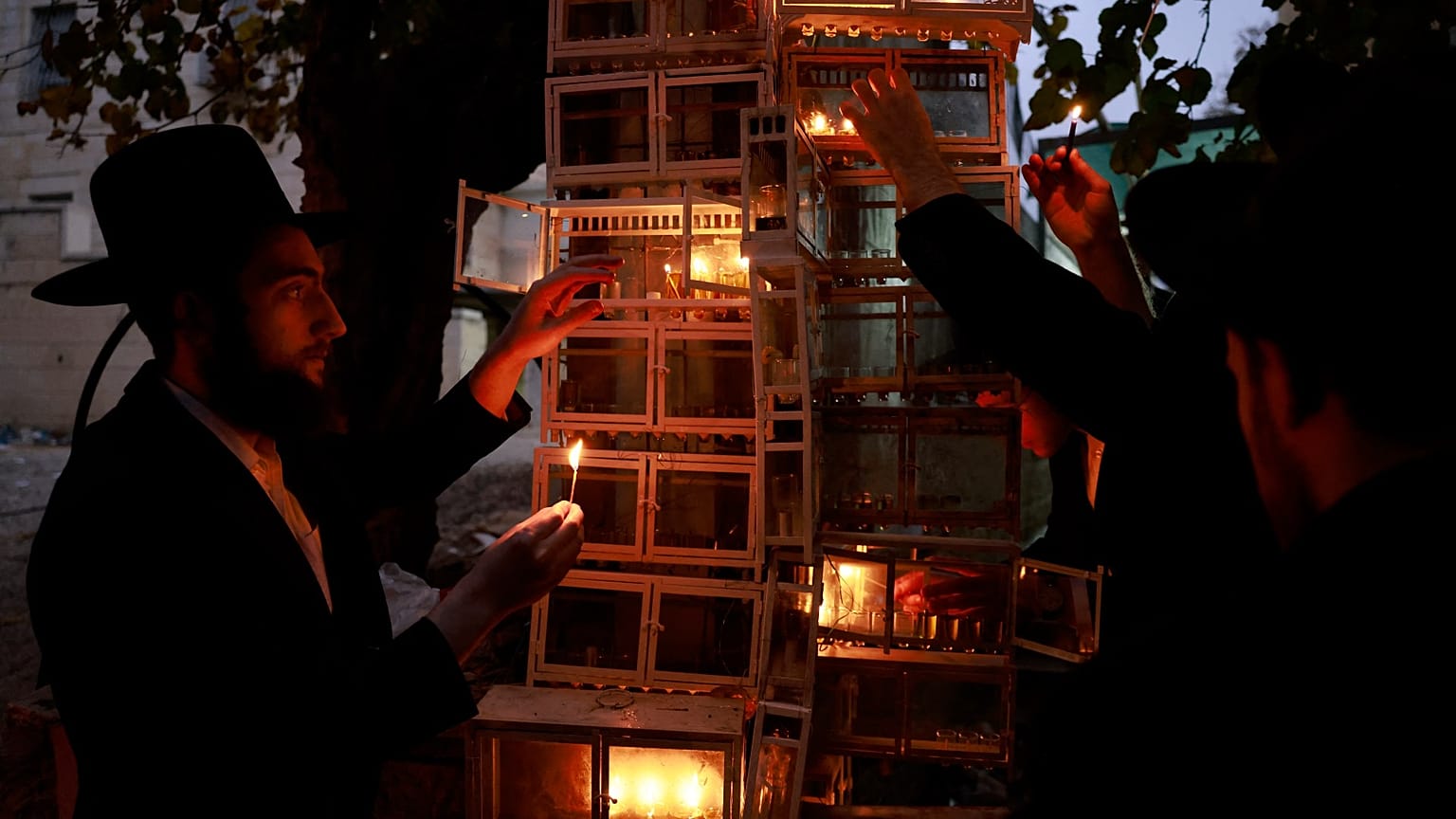 Des juifs ultra-orthodoxes allument des bougies lors de la quatrième nuit de la fête juive, Hanoukka, à Jérusalem - 21.12. 2022. 